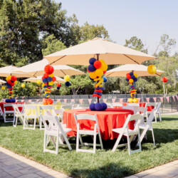 A table and chairs set up for an outdoor party.