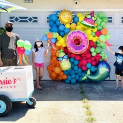 A family standing in front of an ice cream cart.