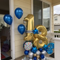 A number 1 3 balloon sitting on top of a porch.