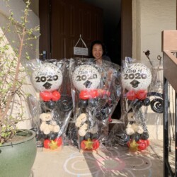 A man standing in front of three bags filled with candy.