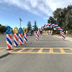 A street with many red, white and blue decorations on the ground.