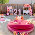 A pink donut pool float in the shape of number 2 1.