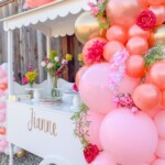 A cart with balloons and flowers on it