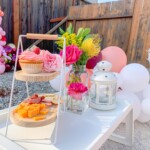 A table with flowers and fruit on it