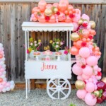 A cart with balloons and flowers on it
