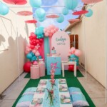 A table with balloons and other decorations on it.