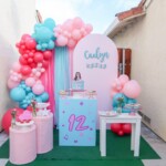 A table with balloons and chairs in front of it
