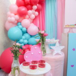 A table with cupcakes and balloons on it